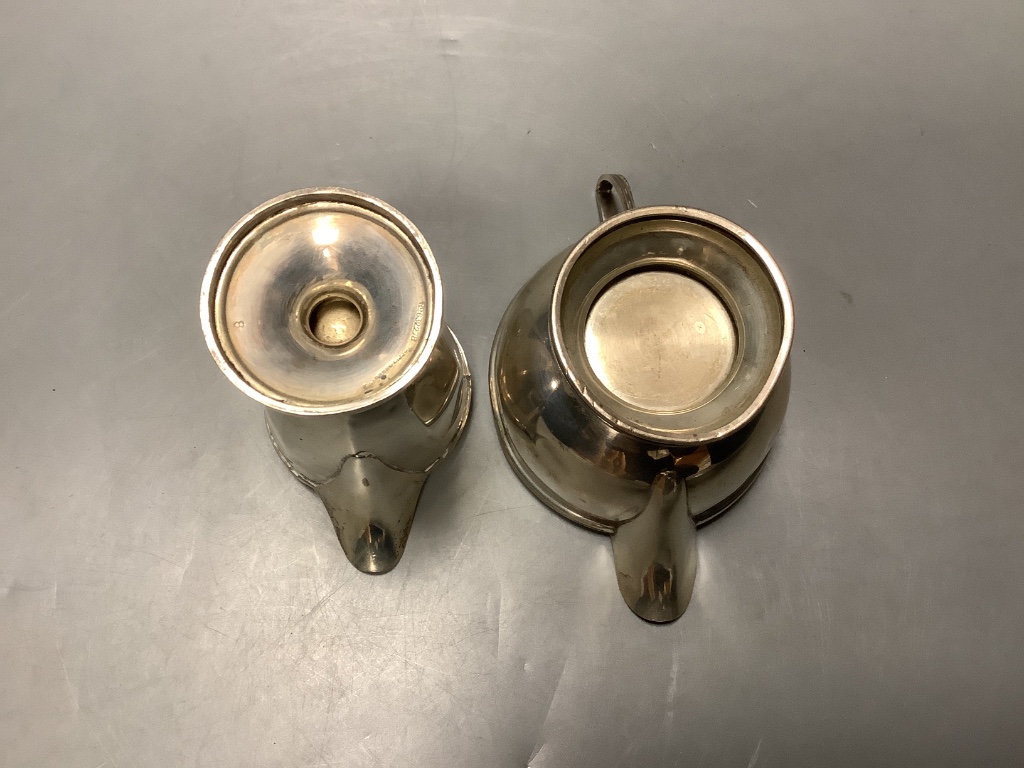 Two George V silver cream jugs and two similar silver sugar bowls